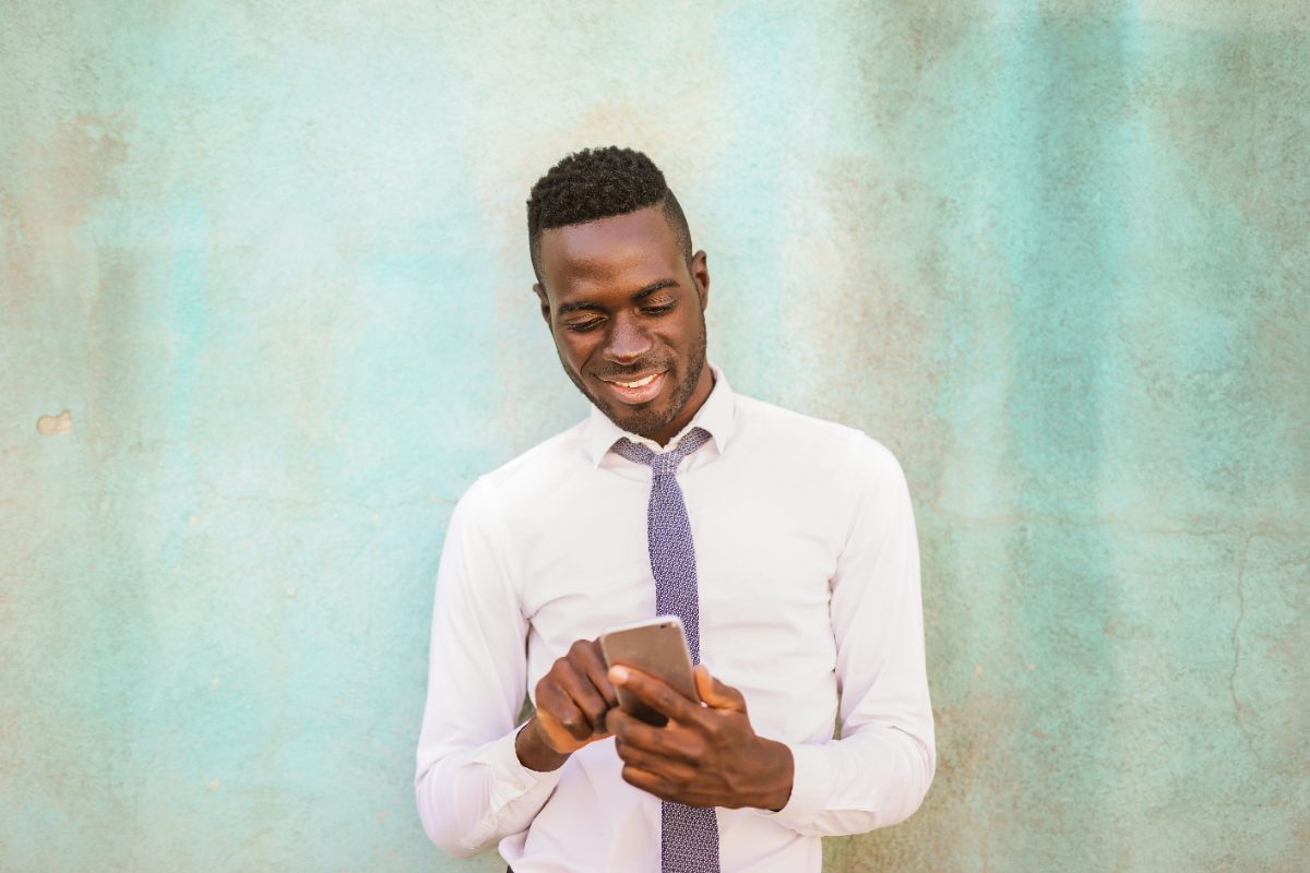 Man smiling at his phone